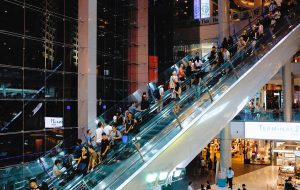 Shoppers on escalator in mall