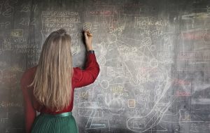 Woman writing on board